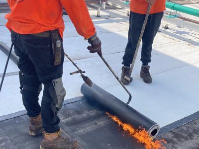 The Process of Installing a Modified Bitumen Roof for a Low-Slope Garage