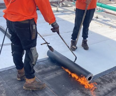 The Process of Installing a Modified Bitumen Roof for a Low-Slope Garage